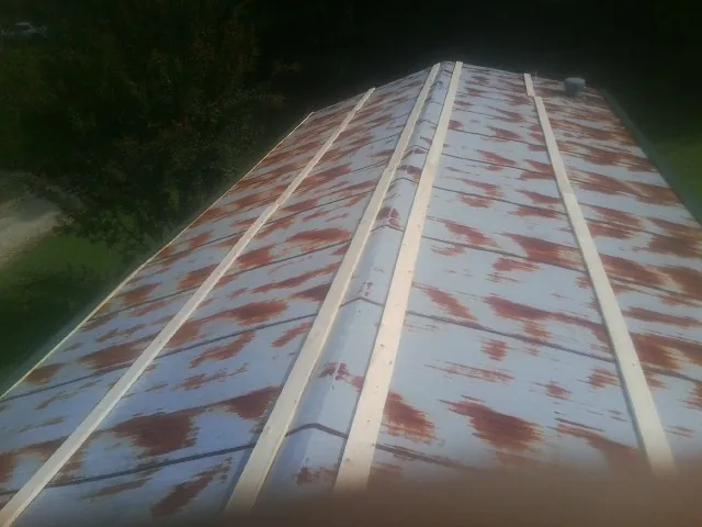 Rusted metal roof panels with new wood purlins before replacement — Storm Damage Roof Repair in Tarentum by Roofing Brothers