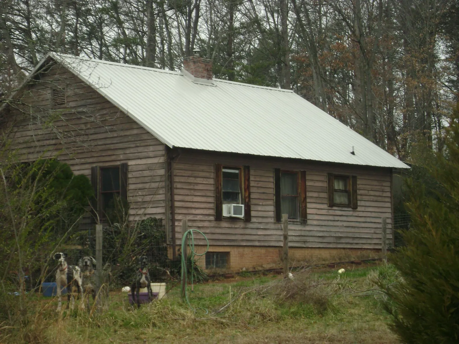 White metal roof on an old wood sided farmhouse, from a Metal Roof Installation job in Tarentum